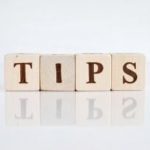 Wooden blocks spelling "TIPS," reflecting advice for home plumbing and HVAC efficiency.