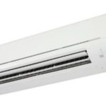 Air conditioning unit mounted on a wall, representing HVAC maintenance and efficiency for home cooling systems.