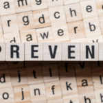 Scrabble tiles spelling "PREVENT" on a background of mixed letters, emphasizing the importance of preventive maintenance for heating systems.