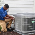HVAC technician servicing an air conditioning unit, emphasizing maintenance for improved home air quality and efficiency.