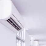 Wall-mounted air conditioning unit in a bright, contemporary room by Carmine's Plumbing, Heating & Air Conditioning.