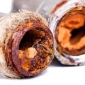 Rusty pipes with corroded interiors showcasing deterioration, relevant to Carmine's Plumbing services for home maintenance.